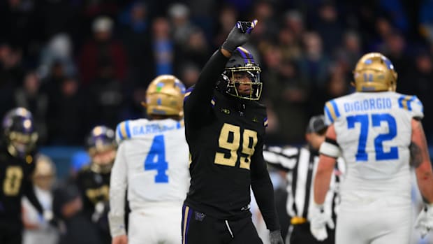 Washington Huskies defensive lineman Russell Davis II (99) celebrates after sacking UCLA Bruins quarterback Ethan Garbers