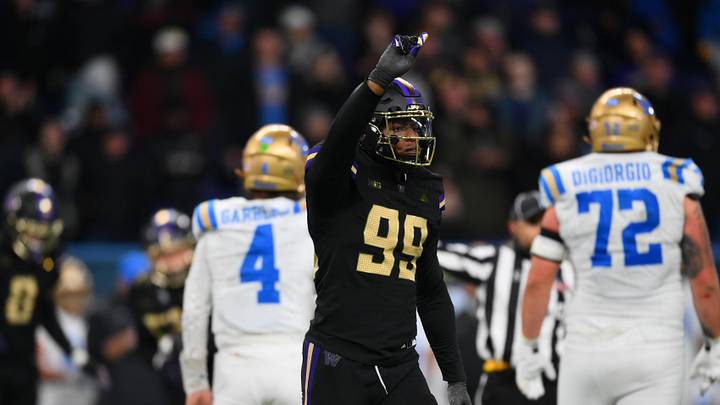 Nov 15, 2024; Seattle, Washington, USA; Washington Huskies defensive lineman Russell Davis II (99) celebrates after sacking UCLA Bruins quarterback Ethan Garbers (4) during the second half at Alaska Airlines Field at Husky Stadium. Mandatory Credit: Steven Bisig-Imagn Images