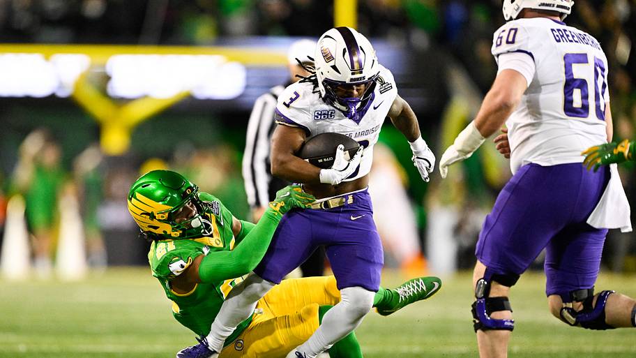 James Madison Dukes running back Wayne Knight rushes as Oregon Ducks defensive back Aaron Flowers defends.