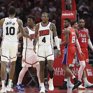 Mar 17, 2025; Houston, Texas, USA; Houston Rockets guard Jalen Green (4) reacts with forward Jabari Smith Jr. (10) after a play during overtime against the Philadelphia 76ers at Toyota Center. Mandatory Credit: Troy Taormina-Imagn Images
