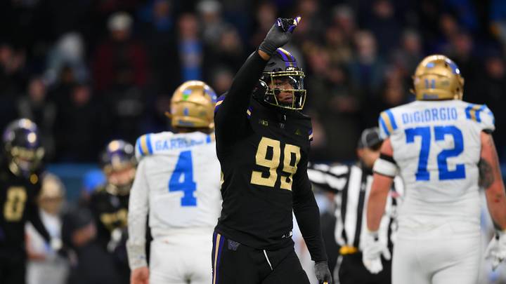 Nov 15, 2024; Seattle, Washington, USA; Washington Huskies defensive lineman Russell Davis II (99) celebrates after sacking UCLA Bruins quarterback Ethan Garbers (4) during the second half at Alaska Airlines Field at Husky Stadium. Mandatory Credit: Steven Bisig-Imagn Images