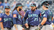 Sep 18, 2025; Kansas City, Missouri, USA; Seattle Mariners relief pitcher Andres Munoz (75) and catcher Cal Raleigh (29) conference at the mound against the Kansas City Royals during the ninth inning at Kauffman Stadium. Mandatory Credit: Denny Medley-Imagn Images