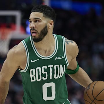 Boston Celtics forward Jayson Tatum dribbles the ball.