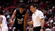 Cincinnati Bearcats head coach Wes Miller speaks with Cincinnati Bearcats forward Baba Miller (18) in the first half of the NCAA Basketball game at Heritage Bank Center in Cincinnati on Nov. 21, 2025.