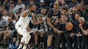 Mar 9, 2025; Minneapolis, Minnesota, USA; San Antonio Spurs guard Chris Paul (3) dribbles the ball as Minnesota Timberwolves guard Mike Conley (10) plays defense in the second half at Target Center.