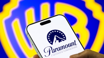 Paramount Logo on Smartphone Against Warner Bros. Discovery Background
