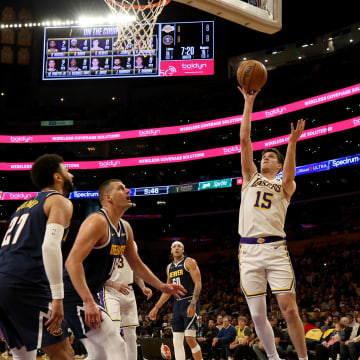 Apr 27, 2024; Los Angeles, California, USA; Los Angeles Lakers guard Austin Reaves (15) shoots against Denver Nuggets center Nikola Jokic (15) during the first quarter in game four of the first round for the 2024 NBA playoffs at Crypto.com Arena.