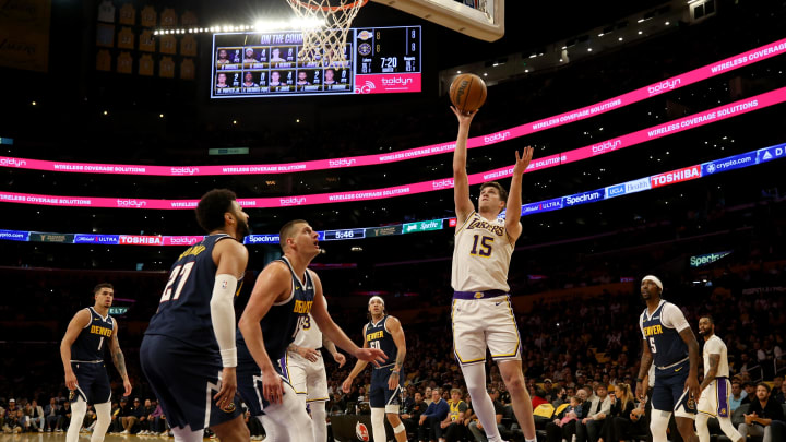 Apr 27, 2024; Los Angeles, California, USA; Los Angeles Lakers guard Austin Reaves (15) shoots against Denver Nuggets center Nikola Jokic (15) during the first quarter in game four of the first round for the 2024 NBA playoffs at Crypto.com Arena.