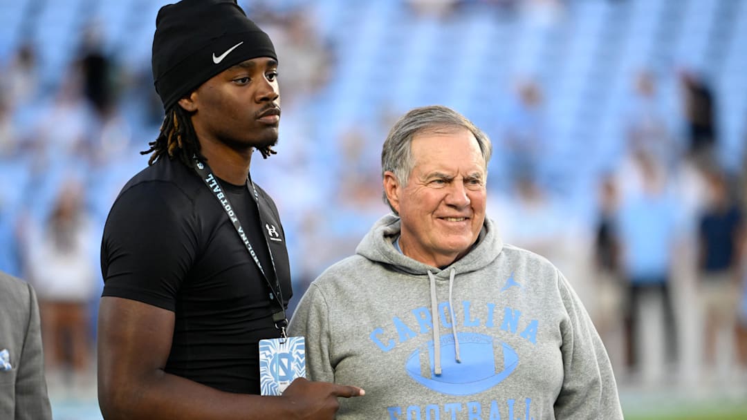 Sep 1, 2025; Chapel Hill, North Carolina, USA;  North Carolina Tar Heels head coach Bill Belichick with a recruit before the game at Kenan Stadium. Mandatory Credit: Bob Donnan-Imagn Images