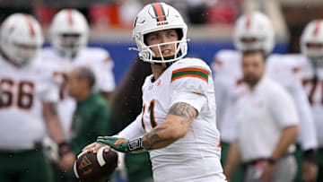 Nov 1, 2025; Dallas, Texas, USA;  SMU Miami Hurricanes quarterback Carson Beck (11) warms up before the game against the SMU Mustangs at Gerald J. Ford Stadium. Mandatory Credit: Jerome Miron-Imagn Images