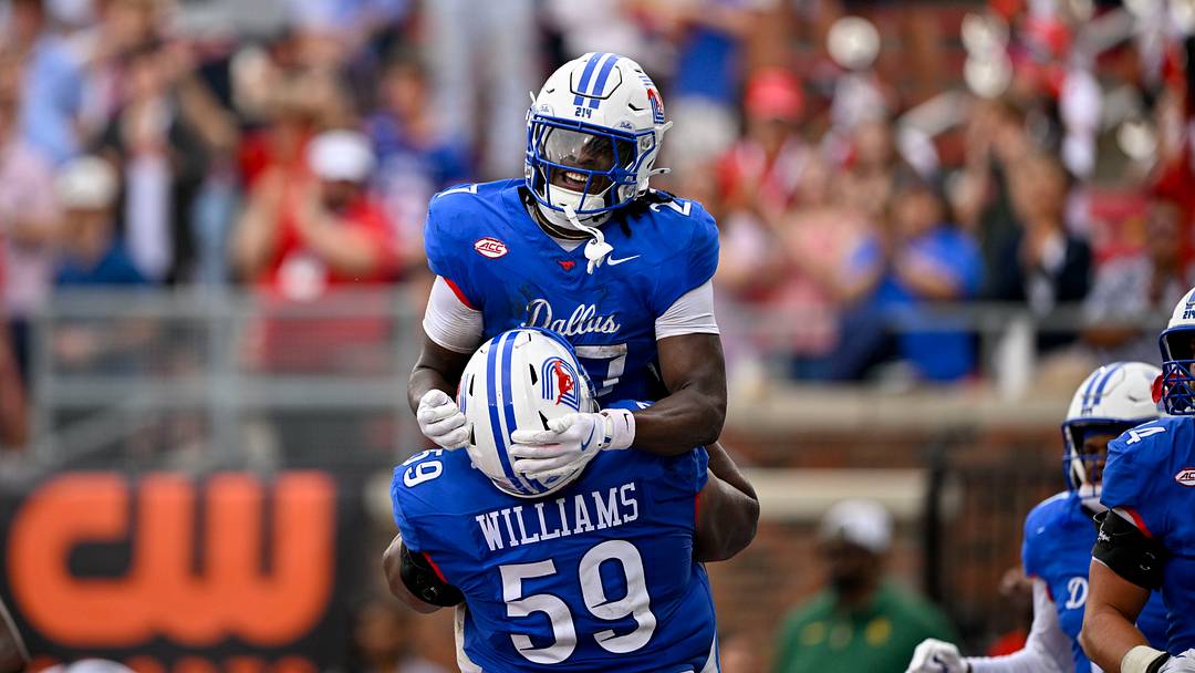 Sep 6, 2025; Dallas, Texas, USA; SMU Mustangs offensive lineman PJ Williams (59) celebrates with running back T.J. Harden (27) during the game between the SMU Mustangs and the Baylor Bears at Gerald J. Ford Stadium. Mandatory Credit: Jerome Miron-Imagn Images Sep 6, 2025; Dallas, Texas, USA; SMU Mustangs offensive lineman PJ Williams (59) celebrates with running back T.J. Harden (27) during the game between the SMU Mustangs and the Baylor Bears at Gerald J. Ford Stadium. Mandatory Credit: Jerome Miron-Imagn Images