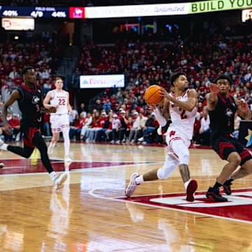 Wisconsin Badgers senior guard Nick Boyd drives to the rim in the first half against Northern Illinois guard Makhai Valentine in a nonconference game at the Kohl Center on November 7, 2025.