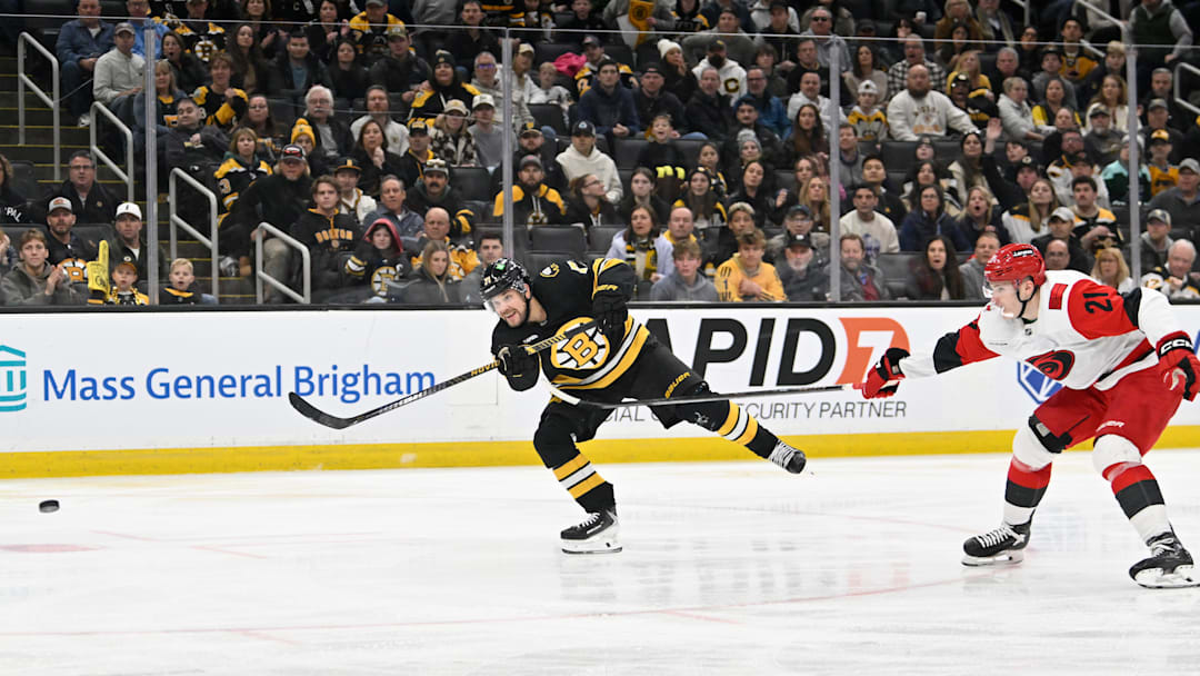 Nov 1, 2025; Boston, Massachusetts, USA; Boston Bruins left wing Viktor Arvidsson (71) scores a goal with pressure from Carolina Hurricanes defenseman Alexander Nikishin (21) during the third period at TD Garden. Mandatory Credit: Eric Canha-Imagn Images