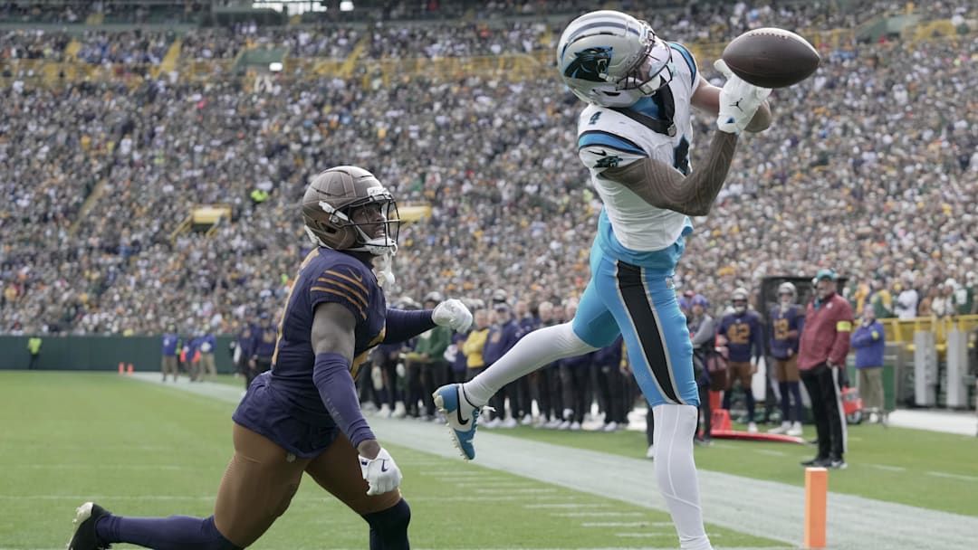 Tetairoa McMillan is unable to catch a would-be touchdown while being covered by Green Bay Packers cornerback Nate Hobbs 