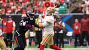 Oct 26, 2025; Houston, Texas, USA; San Francisco 49ers quarterback Mac Jones (10) throws the ball under pressure from Houston Texans defensive end Will Anderson Jr. (51) during the first quarter at NRG Stadium. Mandatory Credit: Troy Taormina-Imagn Images