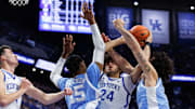 Dec 2, 2025; Lexington, Kentucky, USA; Kentucky Wildcats center Malachi Moreno (24) attempts to grab the rebound against North Carolina Tar Heels forwards Jarin Stevenson (15) and Zayden High (1) during the first half at Rupp Arena at Central Bank Center. Mandatory Credit: Jordan Prather-Imagn Images