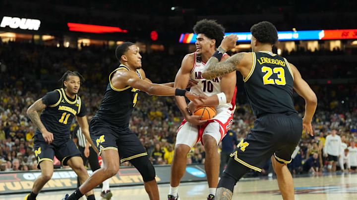 Apr 4, 2026; Indianapolis, IN, USA;  Arizona Wildcats forward Koa Peat (10) is defended by Michigan Wolverines guard Nimari Burnett (4) and Michigan Wolverines forward Yaxel Lendeborg (23) in the second half during a semifinal of the Final Four of the men's 2026 NCAA Tournament at Lucas Oil Stadium. Mandatory Credit: Robert Deutsch-Imagn Images