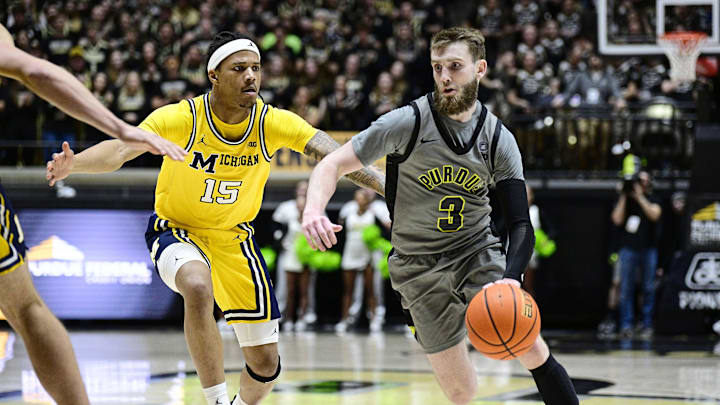 Jan 24, 2025; West Lafayette, Indiana, USA; Purdue Boilermakers guard Braden Smith (3) drives the ball down court past Michigan Wolverines guard Rubin Jones (15) during the second half at Mackey Arena. Mandatory Credit: Marc Lebryk-Imagn Images