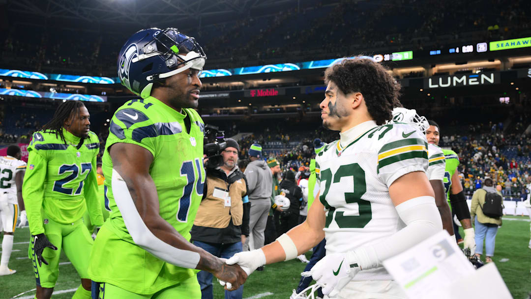 Dec 15, 2024; Seattle, Washington, USA; Seattle Seahawks wide receiver DK Metcalf (14) and Green Bay Packers safety Evan Williams (33) shake hands after the game at Lumen Field. Mandatory Credit: Steven Bisig-Imagn Images