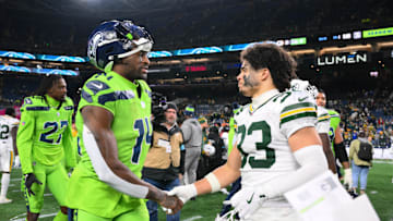Dec 15, 2024; Seattle, Washington, USA; Seattle Seahawks wide receiver DK Metcalf (14) and Green Bay Packers safety Evan Williams (33) shake hands after the game at Lumen Field. Mandatory Credit: Steven Bisig-Imagn Images