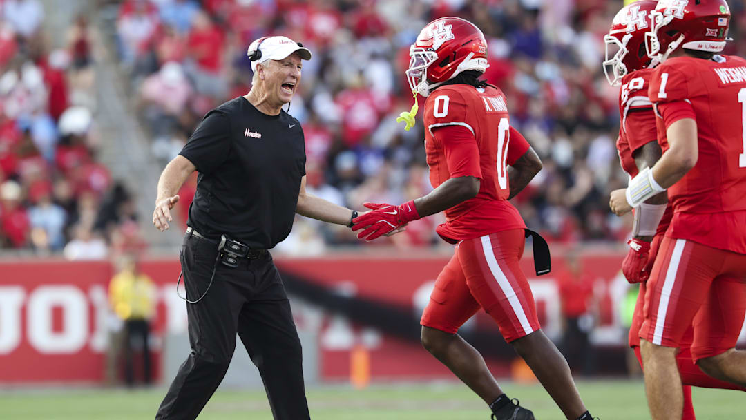 Nov 22, 2025; Houston, Texas, USA; Houston Cougars head coach Willie Fritz celebrates with wide receiver Amare Thomas (0) after Thomas scores a touchdown during the second quarter against the TCU Horned Frogs at TDECU Stadium. Mandatory Credit: Troy Taormina-Imagn Images