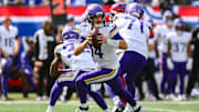 Sep 8, 2024; East Rutherford, New Jersey, USA; Minnesota Vikings quarterback Sam Darnold (14) rolls out to pass against the New York Giants during the second half at MetLife Stadium. Mandatory Credit: John Jones-Imagn Images