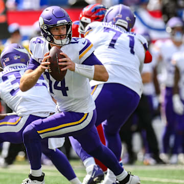 Sep 8, 2024; East Rutherford, New Jersey, USA; Minnesota Vikings quarterback Sam Darnold (14) rolls out to pass against the New York Giants during the second half at MetLife Stadium. Mandatory Credit: John Jones-Imagn Images