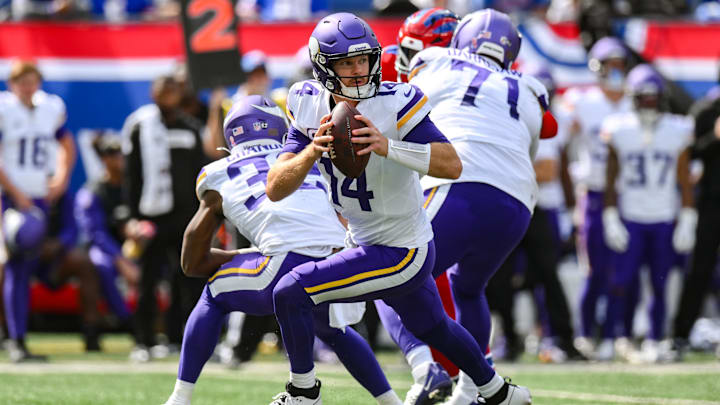 Sep 8, 2024; East Rutherford, New Jersey, USA; Minnesota Vikings quarterback Sam Darnold (14) rolls out to pass against the New York Giants during the second half at MetLife Stadium. Mandatory Credit: John Jones-Imagn Images