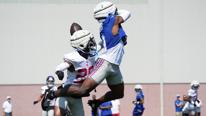 Jul 26, 2024; East Rutherford, NJ, USA; New York Giants cornerback Cordale Flott (28) defends New York Giants wide receiver Malik Nabers (9) during training camp at Quest Diagnostics Training Center.  