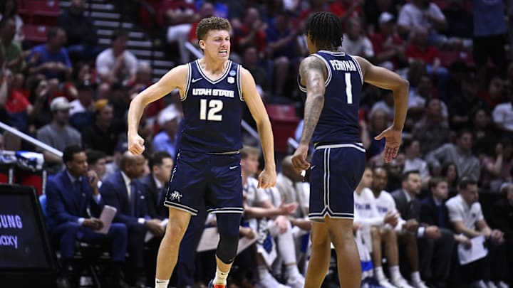 Mar 20, 2026; San Diego, CA, USA; Utah State Aggies guard Mason Falslev (12) and guard Elijah Perryman (1) react in the first half against the Villanova Wildcats during a first round game of the men's 2026 NCAA Tournament at Viejas Arena. Mandatory Credit: Denis Poroy-Imagn Images