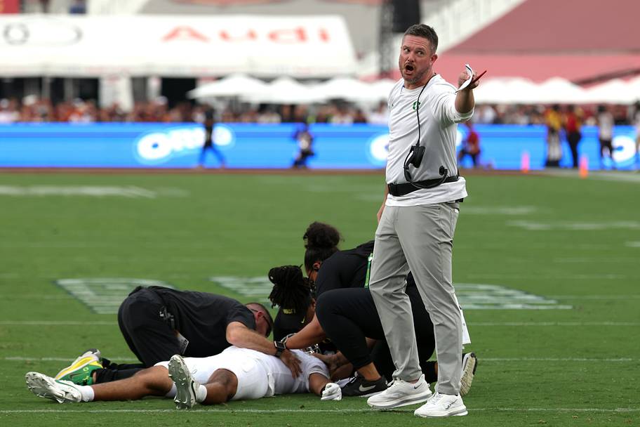 Oregon coach Dan Lanning reacts as quarterback Dante Moore lies on the field after being injured against USC.