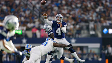 Dallas Cowboys quarterback Dak Prescott throws a pass while being pressured by Detroit Lions defensive tackle DJ Reader.