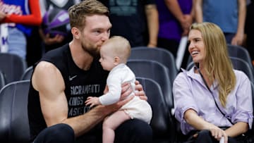 Apr 2, 2024; Sacramento, California, USA; Sacramento Kings forward Domantas Sabonis (10) kisses his daughter Eleven in the forehead before a game against the New Orleans Pelicans at Golden 1 Center. Mandatory Credit: Sergio Estrada-Imagn Images