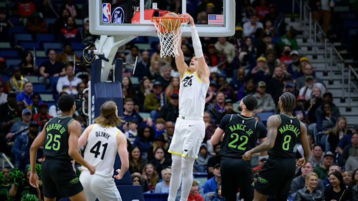 Jan 23, 2024; New Orleans, Louisiana, USA; Utah Jazz center Walker Kessler (24) dunks against New Orleans Pelicans forward Larry Nance Jr. (22) during the first half at Smoothie King Center.