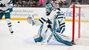 Jan 30, 2025; Seattle, Washington, USA; San Jose Sharks goaltender Yaroslav Askarov (30) deflects a Seattle Kraken goal shot during the first period at Climate Pledge Arena. Mandatory Credit: Steven Bisig-Imagn Images