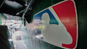 The major league baseball logo is seen on signage near the player's entrance to the field at Oakland-Alameda County Coliseum before the game between the Oakland Athletics and the Milwaukee Brewers.  