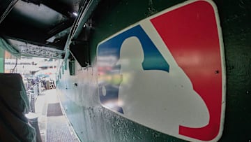 The major league baseball logo is seen on signage near the player's entrance to the field at Oakland-Alameda County Coliseum before the game between the Oakland Athletics and the Milwaukee Brewers.  