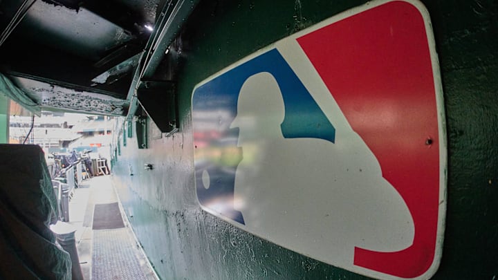 The major league baseball logo is seen on signage near the player's entrance to the field at Oakland-Alameda County Coliseum before the game between the Oakland Athletics and the Milwaukee Brewers.  