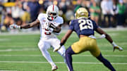 Oct 12, 2024; South Bend, Indiana, USA; Stanford Cardinal running back Chris Davis Jr. (5) runs the ball as Notre Dame Fighting Irish cornerback Christian Gray (29) defends in the first quarter at Notre Dame Stadium. Mandatory Credit: Matt Cashore-Imagn Images
