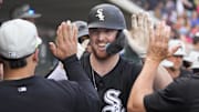 Chicago White Sox designated hitter Tim Elko (91) celebrates with teammates after hitting a solo home run against the Chicago Cubs in spring training at Sloan Park. 