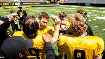 Apr 26, 2025; Iowa City, IA, USA; Iowa quarterbacks (clockwise from left) Jackson Stratton, (19) Mark Gronowski, Jimmy Sullivan and Hank Brown huddle up together after a spring NCAA football open practice at Kinnick Stadium. Mandatory Credit: Joseph Cress-The Des Moines Register
