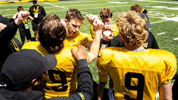 Apr 26, 2025; Iowa City, IA, USA; Iowa quarterbacks (clockwise from left) Jackson Stratton, (19) Mark Gronowski, Jimmy Sullivan and Hank Brown huddle up together after a spring NCAA football open practice at Kinnick Stadium. Mandatory Credit: Joseph Cress-The Des Moines Register