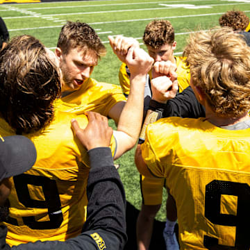 Apr 26, 2025; Iowa City, IA, USA; Iowa quarterbacks (clockwise from left) Jackson Stratton, (19) Mark Gronowski, Jimmy Sullivan and Hank Brown huddle up together after a spring NCAA football open practice at Kinnick Stadium. Mandatory Credit: Joseph Cress-The Des Moines Register