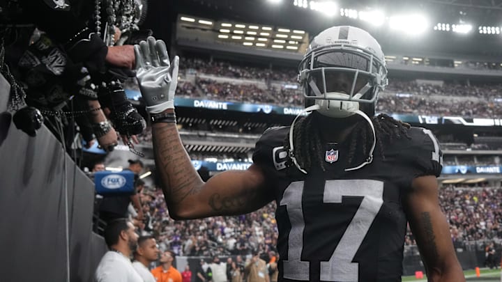 Las Vegas Raiders receiver Davante Adams high fives fans.