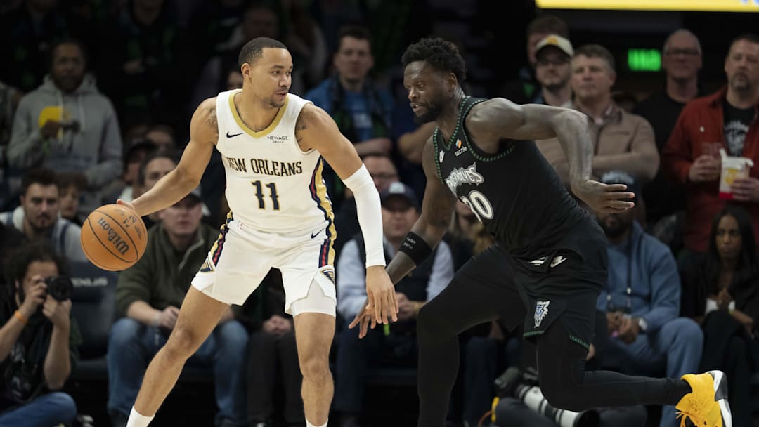 Feb 6, 2026; Minneapolis, Minnesota, USA; New Orleans Pelicans guard Bryce McGowens (11) holds the ball and looks to pass as Minnesota Timberwolves forward Julius Randle (30) plays defense in the second half at Target Center. Mandatory Credit: Jesse Johnson-Imagn Images