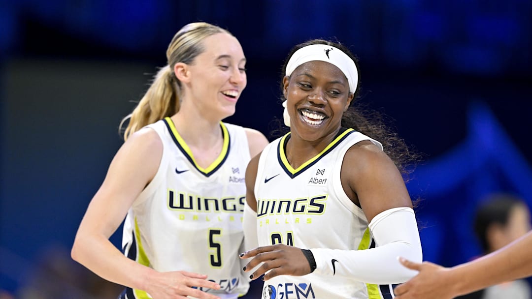 Jul 28, 2025; Arlington, Texas, USA; Dallas Wings guard Paige Bueckers (5) and guard Arike Ogunbowale (24) celebrate during the second half against the New York Liberty at College Park Center. Mandatory Credit: Jerome Miron-Imagn Images