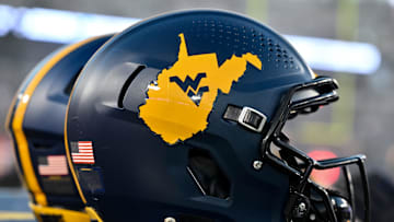 Oct 12, 2023; Houston, Texas, USA; A detailed view of a West Virginia Mountaineers helmet on the sideline during the game against the Houston Cougars  at TDECU Stadium. Mandatory Credit: Maria Lysaker-Imagn Images