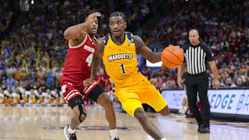 Dec 7, 2024; Milwaukee, Wisconsin, USA;  Marquette Golden Eagles guard Kam Jones (1) drives for the basket in front of Wisconsin Badgers guard Kamari McGee (4) during the second half at Fiserv Forum. Mandatory Credit: Jeff Hanisch-Imagn Images