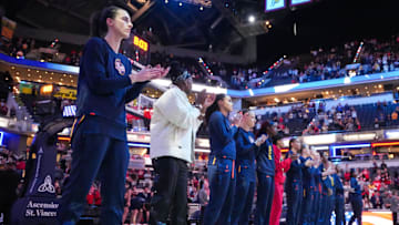 Indiana Fever guard Caitlin Clark (22) stands with the team during the national anthem on Thursday,