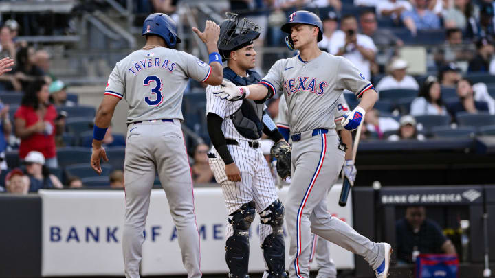 Aug 10, 2024; Bronx, New York, USA; Texas Rangers shortstop Corey Seager (5) is greeted at home plate by Texas Rangers outfielder Leody Taveras (3) after hitting a three run home run against the New York Yankees during the sixth inning at Yankee Stadium. Mandatory Credit: John Jones-USA TODAY Sports